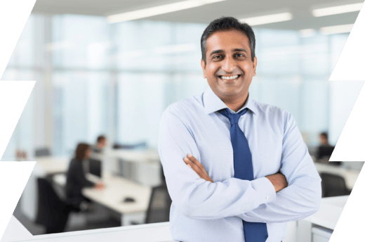 Indian man wearing a shirt and smiling in an office